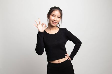 Young Asian woman show OK sign on white backgroundの写真素材