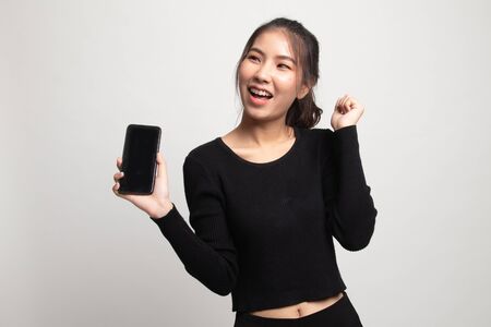 Happy Young Asian woman with mobile phone on white backgroundの写真素材