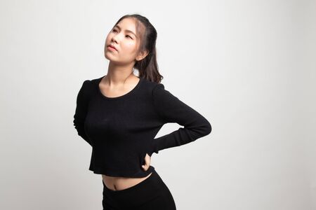 Young Asian woman got back pain on white backgroundの写真素材
