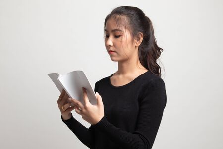 Young Asian woman read a book on white backgroundの写真素材