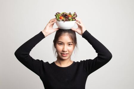Healthy Asian woman with salad on white backgroundの写真素材