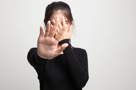 Young Asian woman hide her  face on white backgroundの写真素材