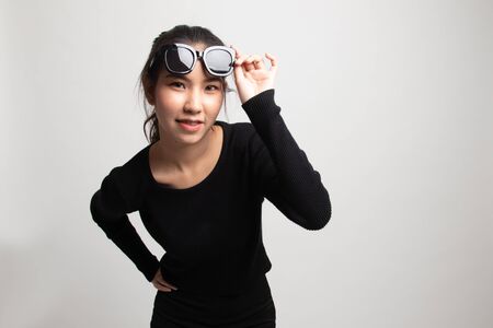 Portrait of a beautiful young asian girl in sunglasses on white backgroundの写真素材