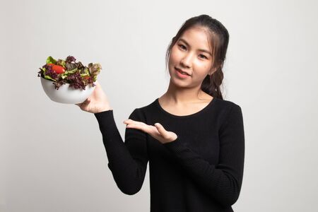 Healthy Asian woman with salad on white backgroundの写真素材