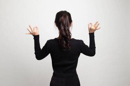 Back view of Asian woman show double OK hand sign on white backgroundの写真素材