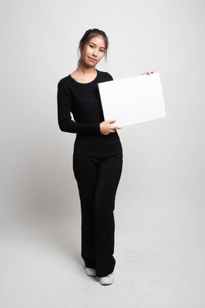 Full body of young Asian woman with white blank sign on white backgroundの写真素材