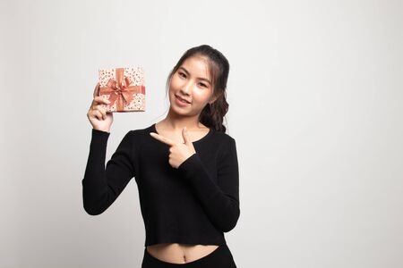 Young Asian woman with a gift box on white backgroundの写真素材