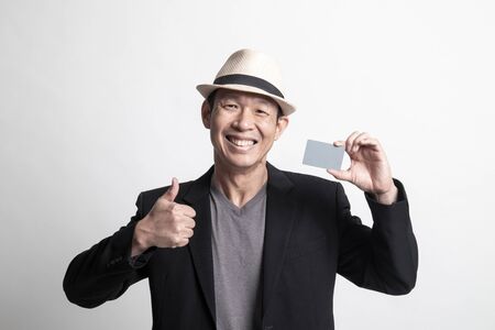 Adult Asian man  thumbs up with a blank card on white backgroundの写真素材