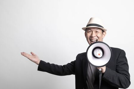 Adult Asian man  announce with megaphone on white backgroundの写真素材