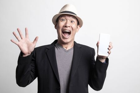 Adult Asian man with mobile phone on white backgroundの写真素材