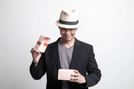 Adult Asian man  open a gift box on white backgroundの写真素材