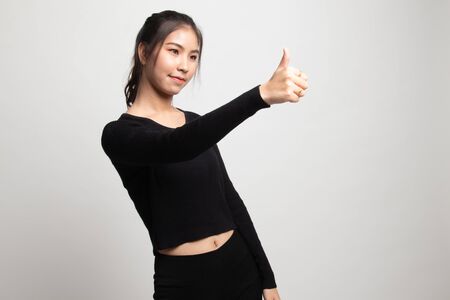 Asian woman thumbs up  and smile on white backgroundの写真素材