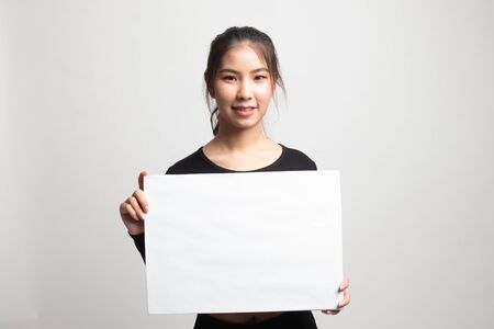 Young Asian woman with white blank sign on white backgroundの写真素材