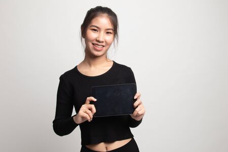 Young Asian woman with a computer tablet on white backgroundの写真素材