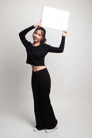 Young Asian woman with white blank sign on white backgroundの写真素材