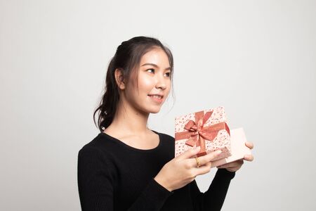 Young Asian woman open a gift box on white backgroundの写真素材