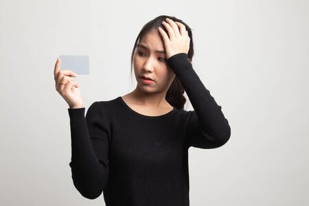 Young Asian woman headache with a blank card on white backgroundの写真素材
