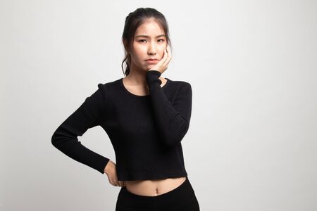 Young Asian woman got toothache on white backgroundの写真素材