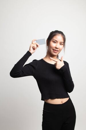 Young Asian woman point to a blank card on white backgroundの写真素材