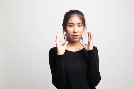 Shocked young Asian woman on white backgroundの写真素材