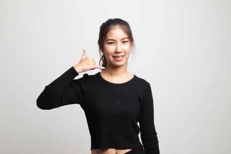 Young Asian woman show with phone gesture on white backgroundの写真素材