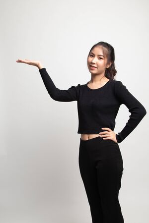 Young Asian woman present with her hand on white backgroundの写真素材