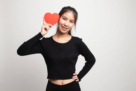 Asian woman with red heart on white backgroundの写真素材