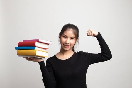 Young Asian woman studying  with may books on white backgroundの写真素材
