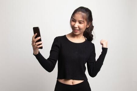 Successful young Asian woman with mobile phone on white backgroundの写真素材