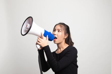 Beautiful young Asian woman announce with megaphone on white backgroundの写真素材