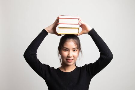 Young Asian woman studying  with may books on white backgroundの写真素材