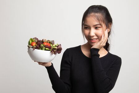 Healthy Asian woman with salad on white backgroundの写真素材