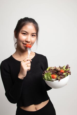 Healthy Asian woman with salad on white backgroundの写真素材