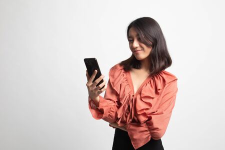 Young Asian woman with mobile phone on white backgroundの写真素材