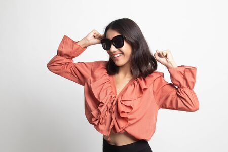 Portrait of a beautiful young asian girl in sunglasses on white backgroundの写真素材