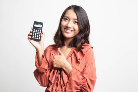 Asian woman thumbs up with calculator on white backgroundの写真素材