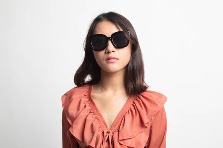 Portrait of a beautiful young asian girl in sunglasses on white backgroundの写真素材