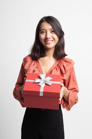 Young Asian woman with a gift box on white backgroundの写真素材