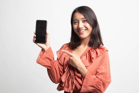 Young Asian woman point to mobile phone on white backgroundの写真素材