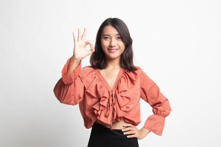 Young Asian woman show OK sign on white backgroundの写真素材