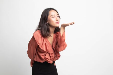 Beautiful young Asian woman blow a kiss on white backgroundの写真素材