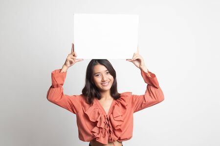 Young Asian woman with white blank sign on white backgroundの写真素材