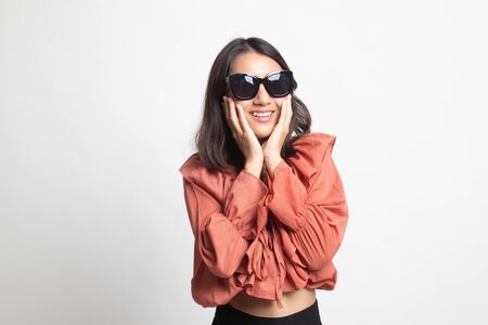 Portrait of a beautiful young asian girl in sunglasses on white backgroundの写真素材
