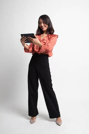 Young Asian woman with a computer tablet on white backgroundの写真素材
