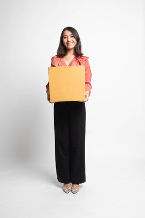Delivery, relocation and unpacking.  young asian woman holding cardboard box on white backgroundの写真素材