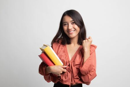 Young Asian woman studying  with may books on white backgroundの写真素材
