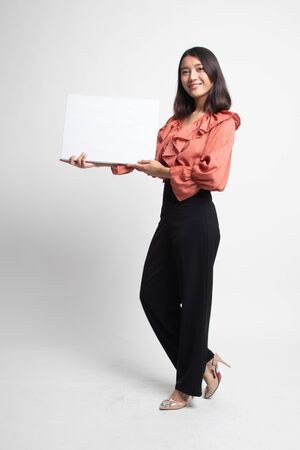 Full body of young Asian woman with white blank sign on white backgroundの写真素材