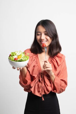 Healthy Asian woman with salad on white backgroundの写真素材
