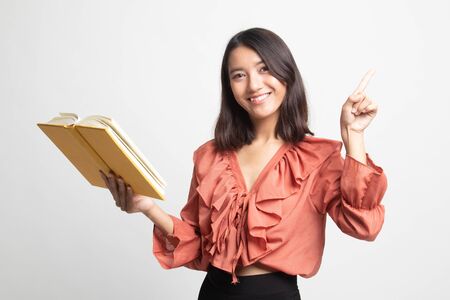 Young Asian woman with a book have an idea on white backgroundの写真素材