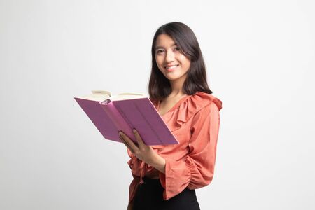 Young Asian woman read a book on white backgroundの写真素材